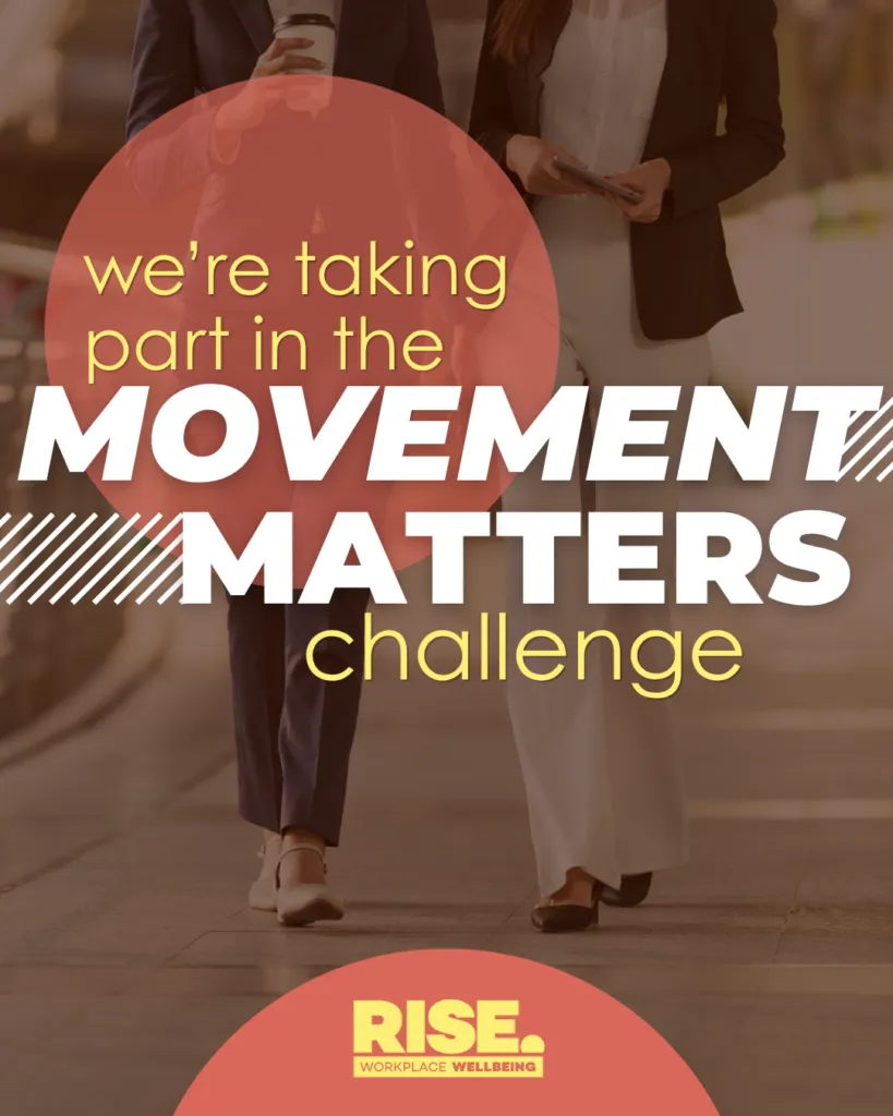 Two colleagues walk together outdoors while chatting, one holding a takeaway coffee. Overlaid text reads: "We're taking part in the Movement Matters Challenge." Rise Workplace Wellbeing logo at the bottom.